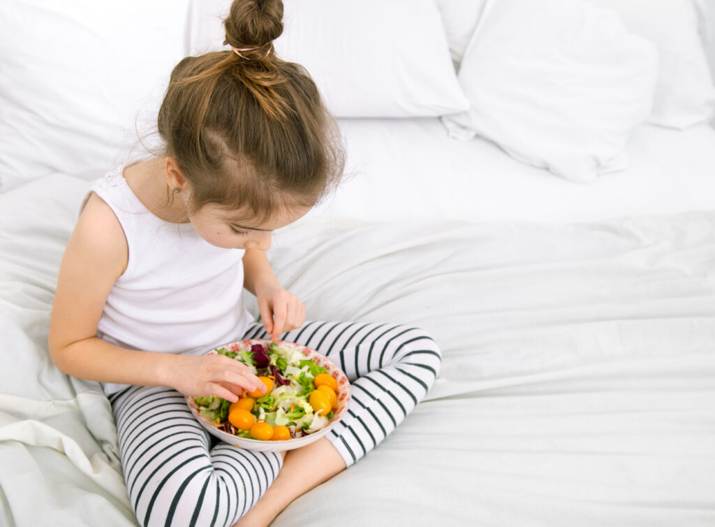cute little girl with fruits and vegetables.