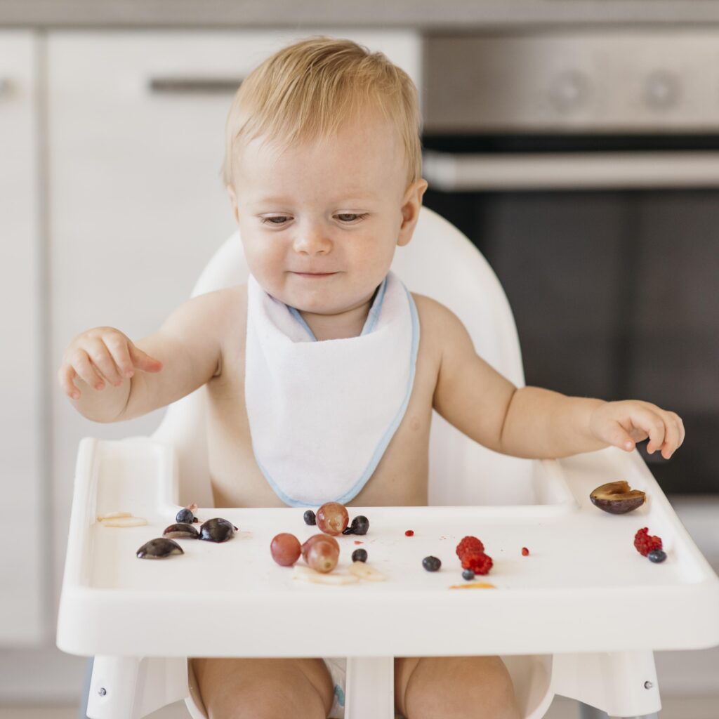 smiley cute baby eating alone
